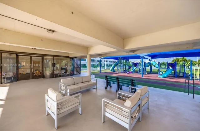 a living room with furniture and a large mirror