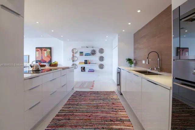 a large white kitchen with sink
