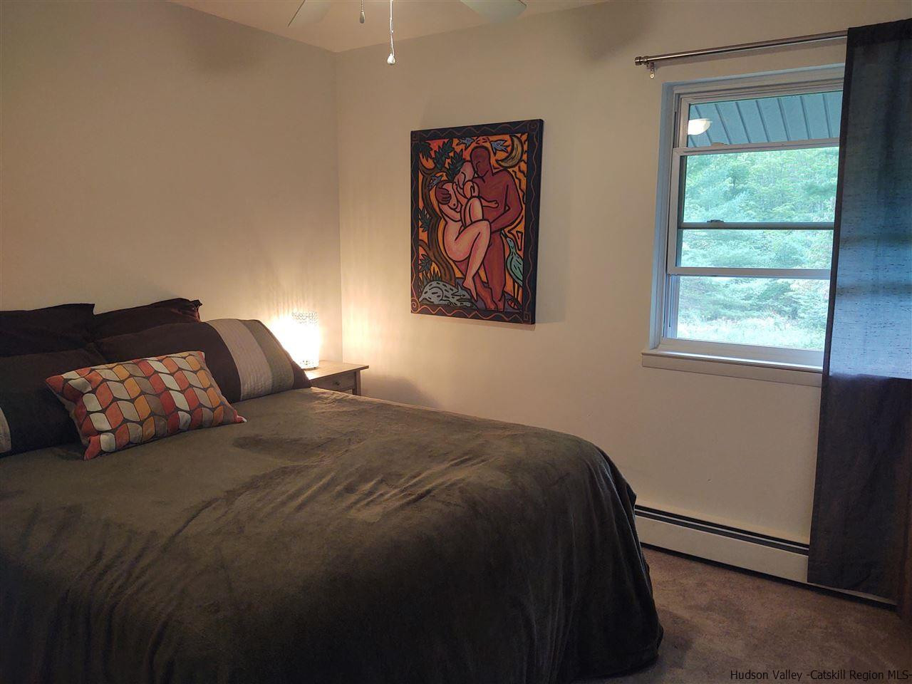 2 Mountain Valley Road Boiceville, NY 12412 - Photo 22 of 35 a bed sitting in a bedroom next to a window