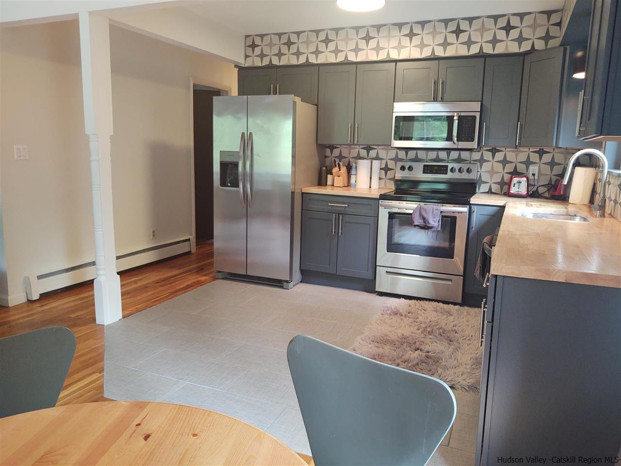 2 Mountain Valley Road Boiceville, NY 12412 - Photo 27 of 35 a kitchen with stainless steel appliances granite countertop a refrigerator a stove and a sink with wooden floor