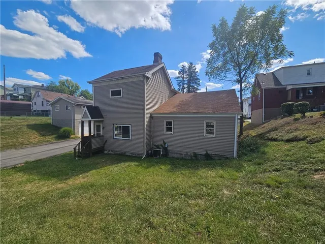 a view of a house with backyard porch and sitting area