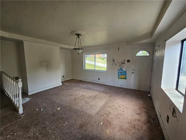 an empty room with windows and entrance