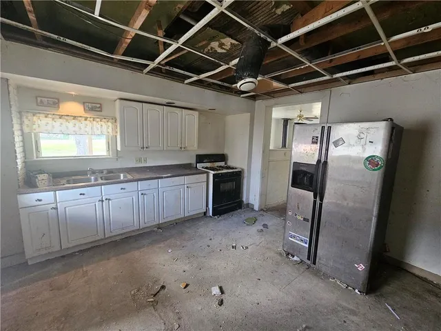 a kitchen with refrigerator and window