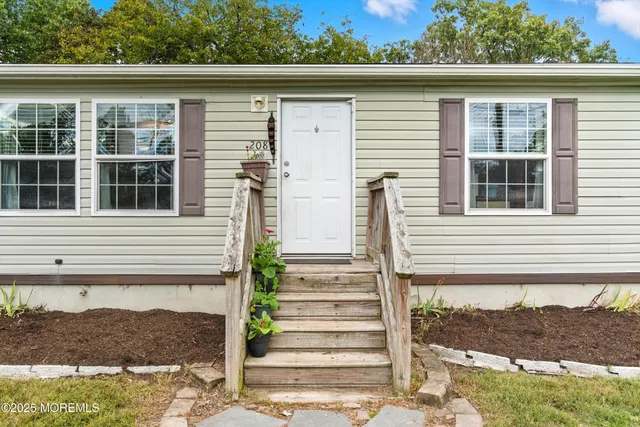 a house that has a big yard with wooden fence