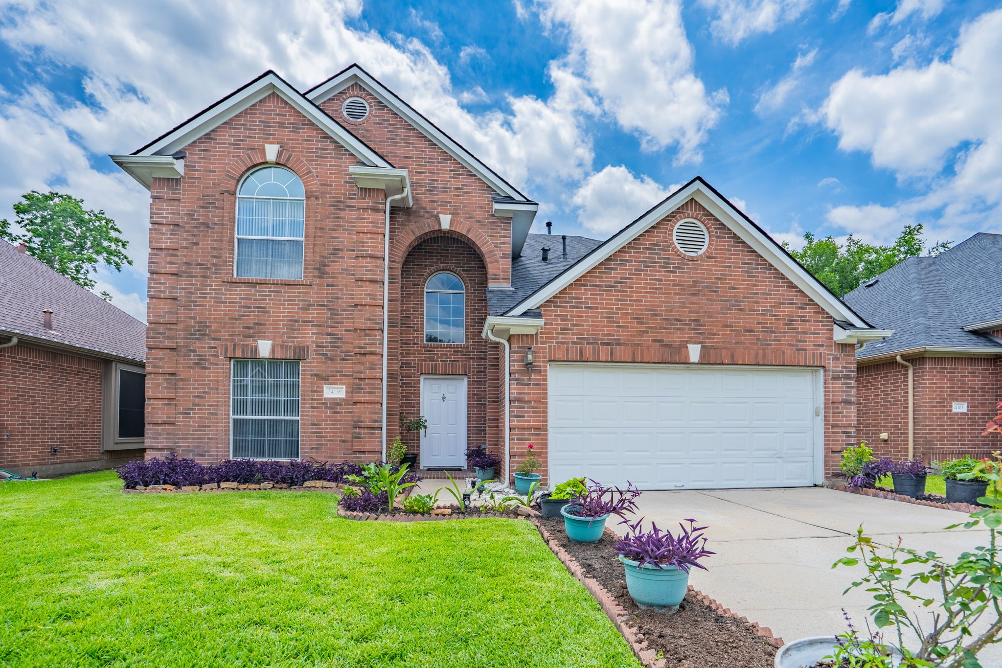 24139 Spring Sunset Drive Spring, TX 77373 - Photo 1 of 26 front view of a house with a yard