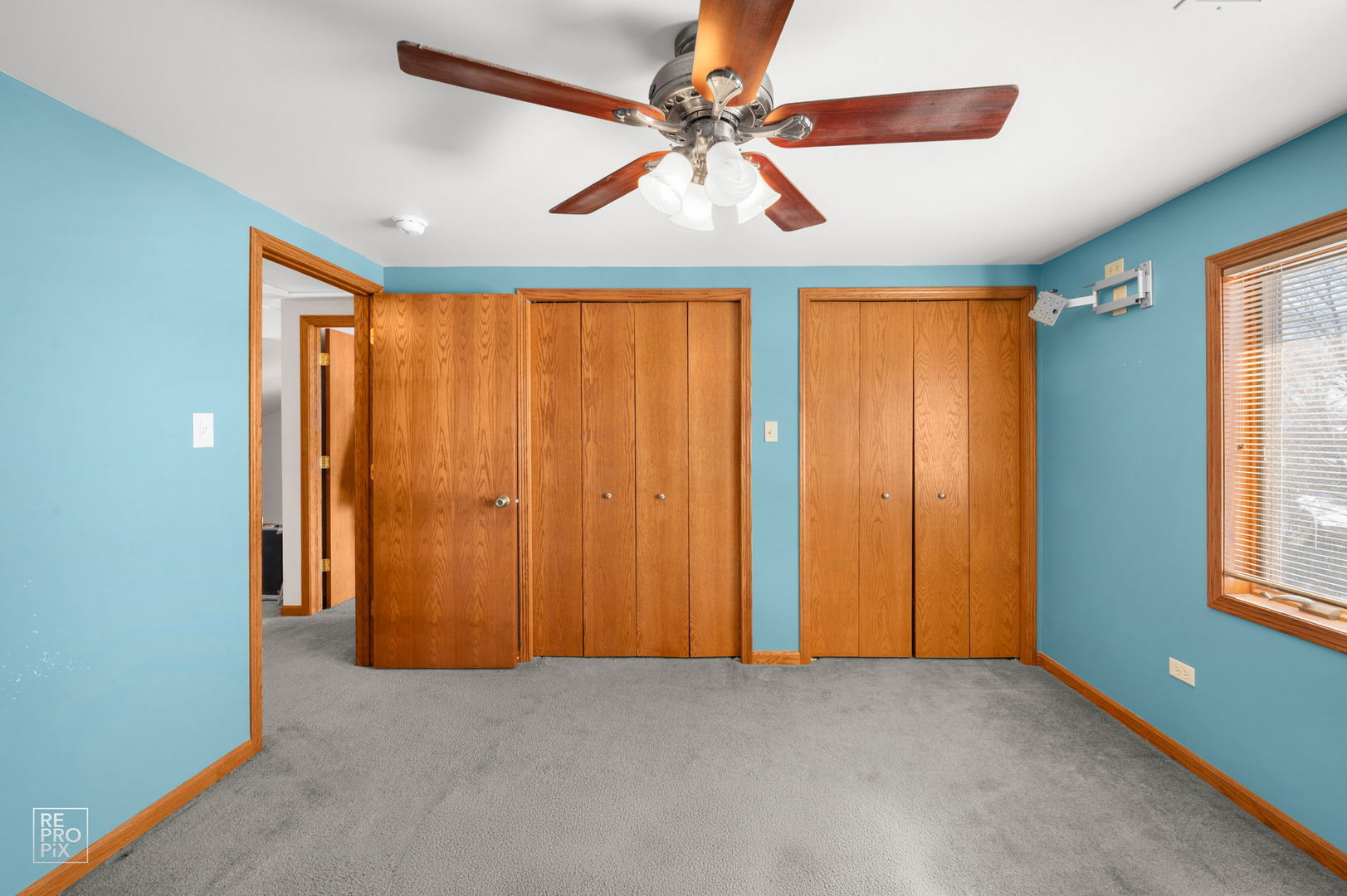 3235 192nd Street Lansing, IL 60438 - Photo 10 of 28 an empty room with windows and chandelier fan