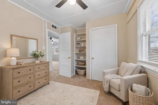 a spacious bedroom with a furniture and a couch