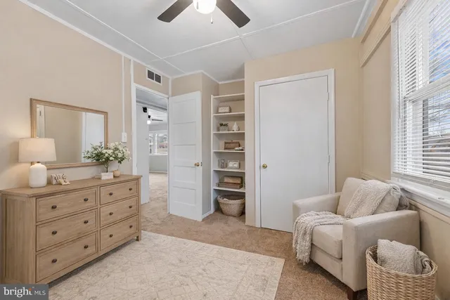 a spacious bedroom with a furniture and a couch