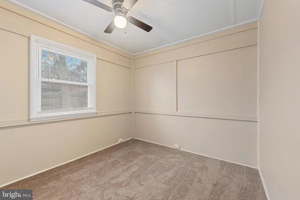a view of a room with rack on the wall and a window