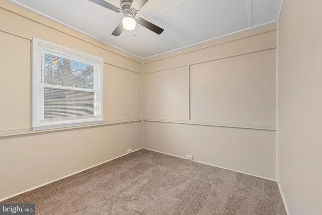 a view of a room with rack on the wall and a window