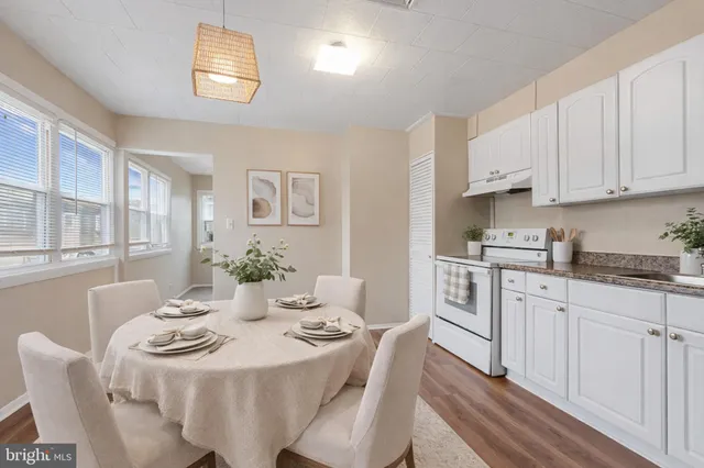 a view of a dining room with furniture and wooden floor