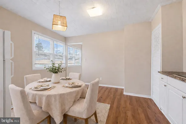 a dining room with furniture and wooden floor