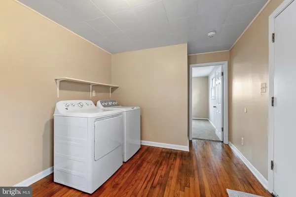 a view of utility room with wooden floor
