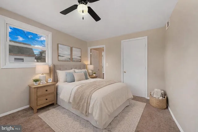 a bedroom with a bed and a painting on the wall