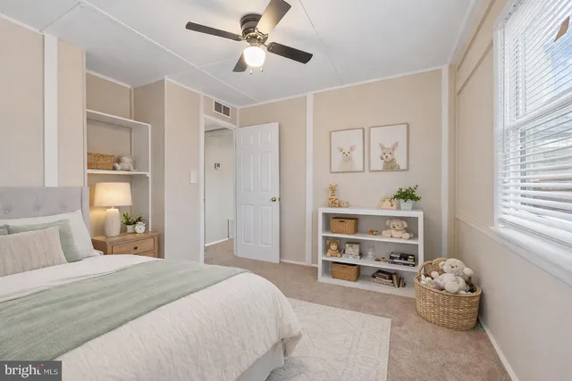 a bedroom with a bed and a window