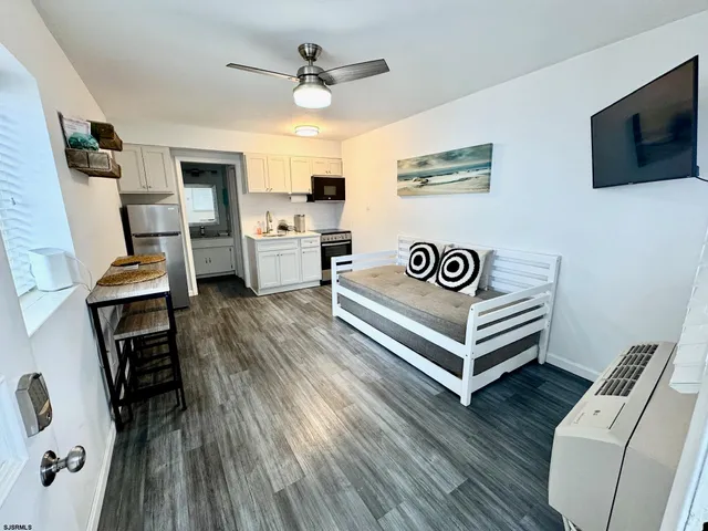 a view of a livingroom with furniture and a flat screen tv