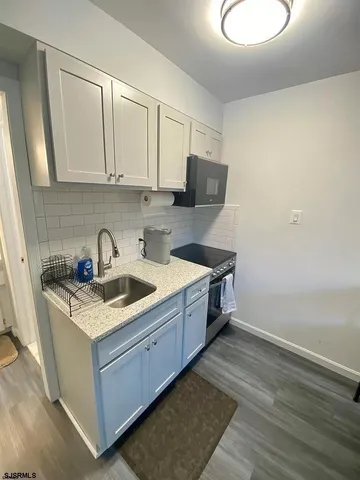 a kitchen with a sink stove and cabinets
