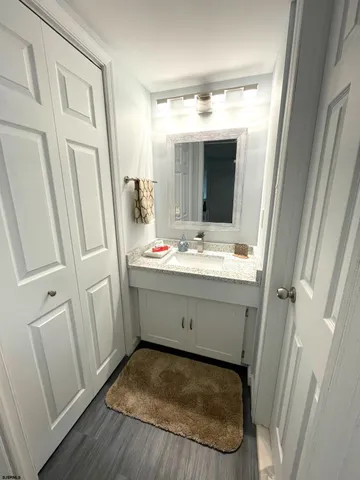 a bathroom with a sink vanity and mirror