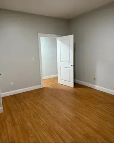 a view of an empty room and wooden floor