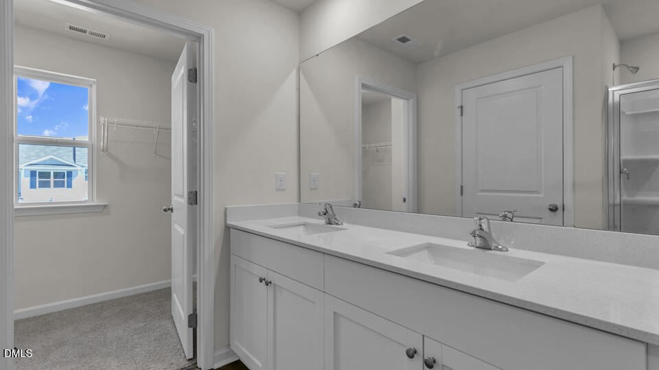 552 Stream Walk Crossing Wendell, NC 27591 - Photo 20 of 42 a bathroom with a sink and a mirror