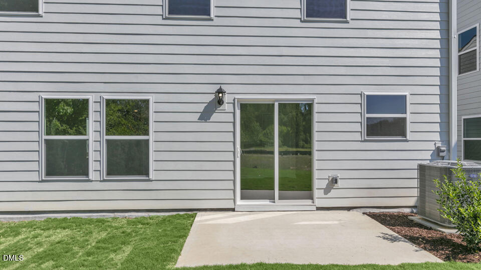 552 Stream Walk Crossing Wendell, NC 27591 - Photo 34 of 42 a view of a house with a large window and yard in front of main door