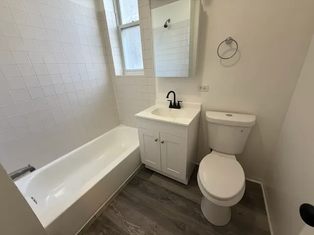 a white toilet sitting next to a bathroom sink