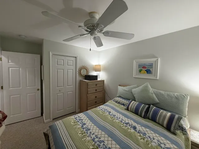 a bedroom with a bed and dresser