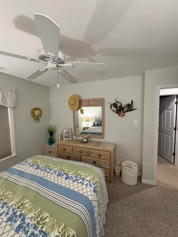 a bathroom with a toilet sink tub and view bedroom