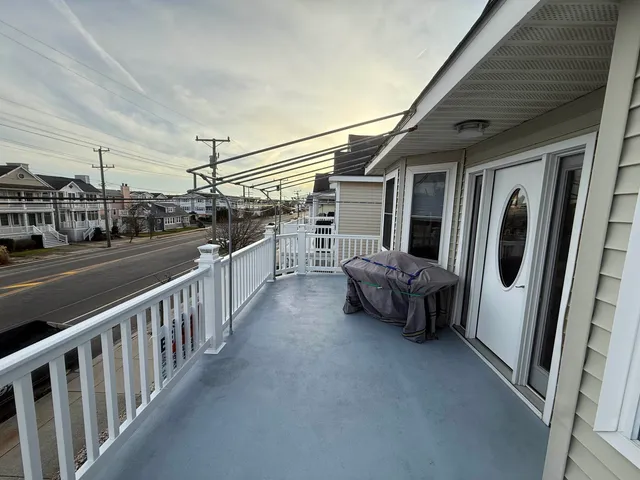 a view of a porch with furniture and floor to ceiling window