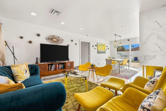 a living room with furniture and a flat screen tv