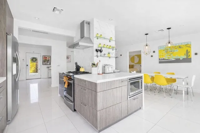 a kitchen with stainless steel appliances a stove a sink and a refrigerator