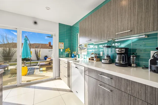 a kitchen with stainless steel appliances a sink stove and refrigerator