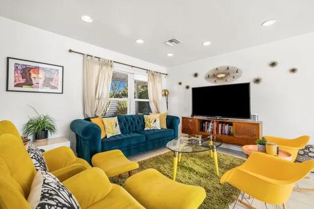 a living room with fireplace furniture and a flat screen tv
