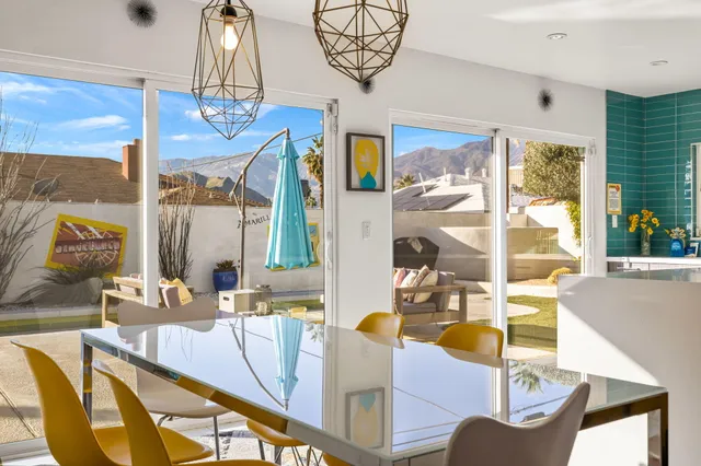 a view of a dining room with furniture and chandelier