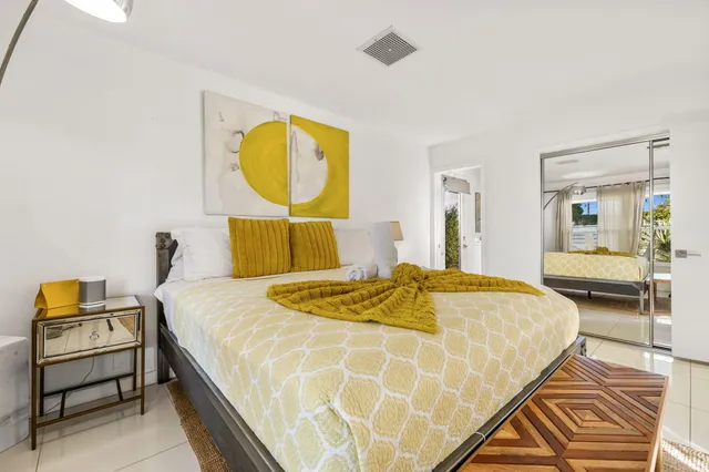 a bedroom with a bed a table and chair