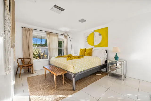 a bedroom with two beds and painting on the wall