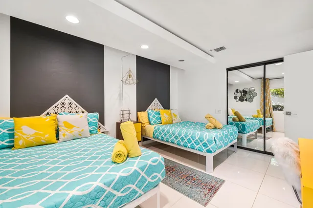 a bedroom with a bed and a view of kitchen