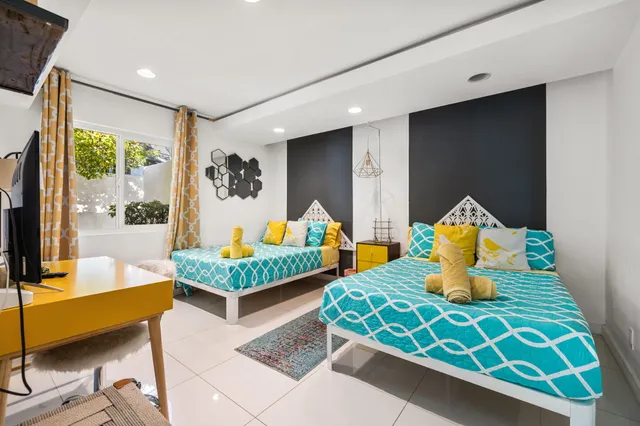 a bedroom with a bed and a painting on the wall