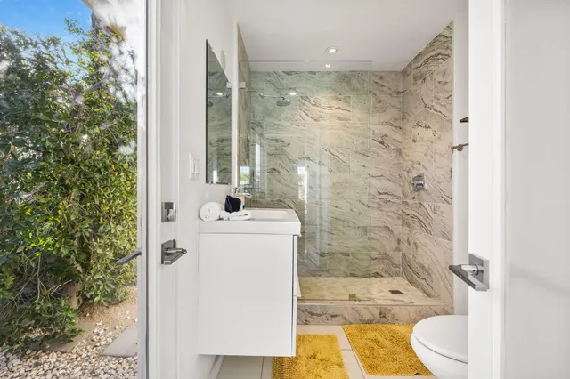 a bathroom with a toilet a sink and shower