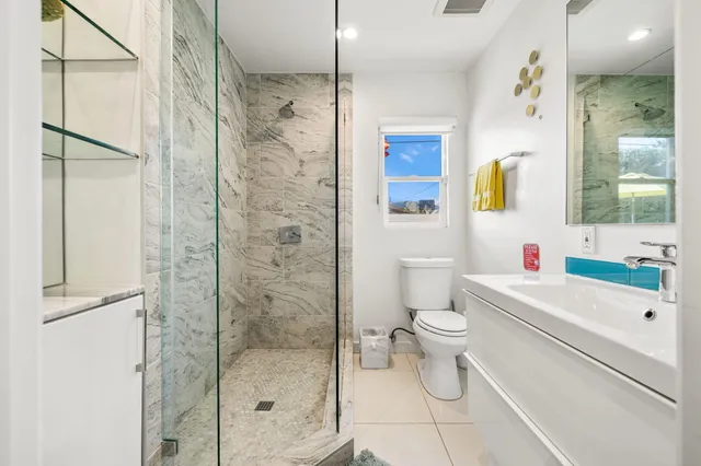 a view of a street with potted plants