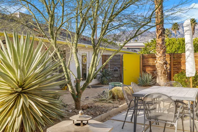 a view of a porch with wooden floor and fence and a living room