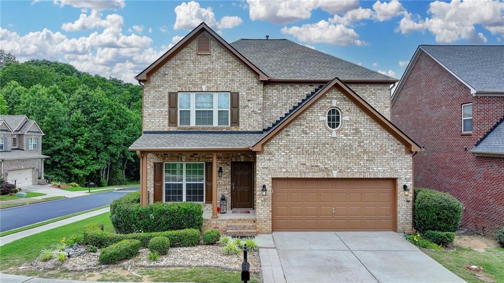 a front view of a house with a garden and plants