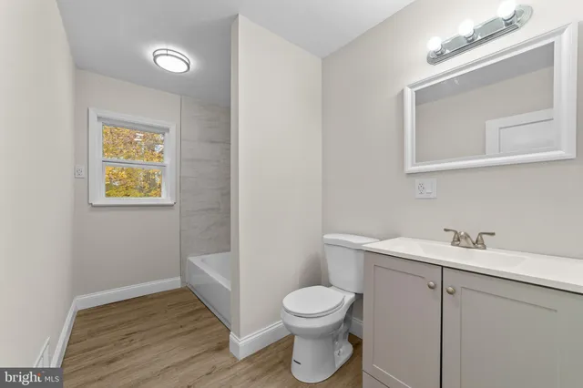 a bathroom with a toilet sink and vanity