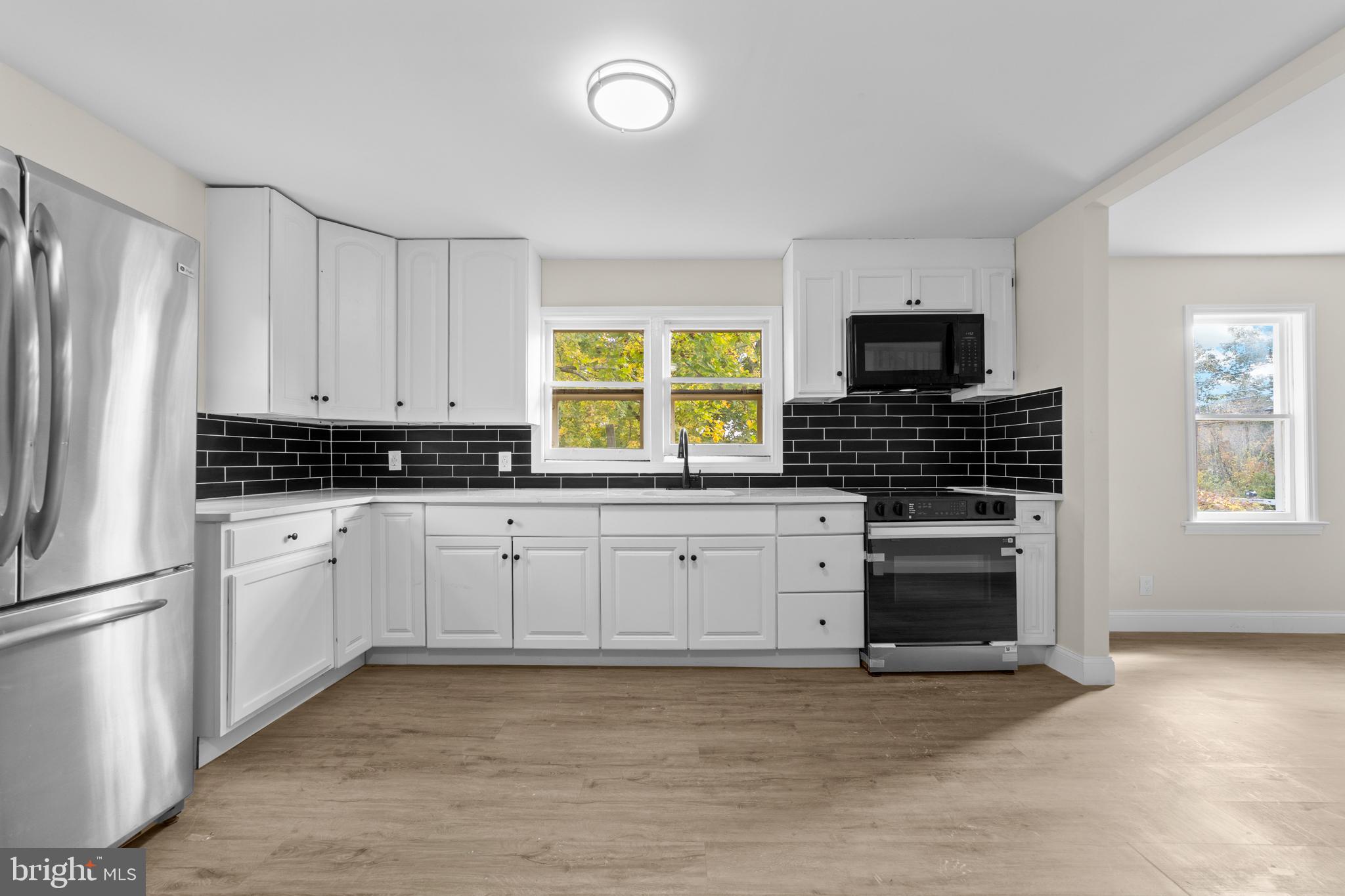 280 Qtn Marlboro Road Salem, NJ 08079 - Photo 8 of 37 a kitchen with granite countertop a stove a sink and a refrigerator