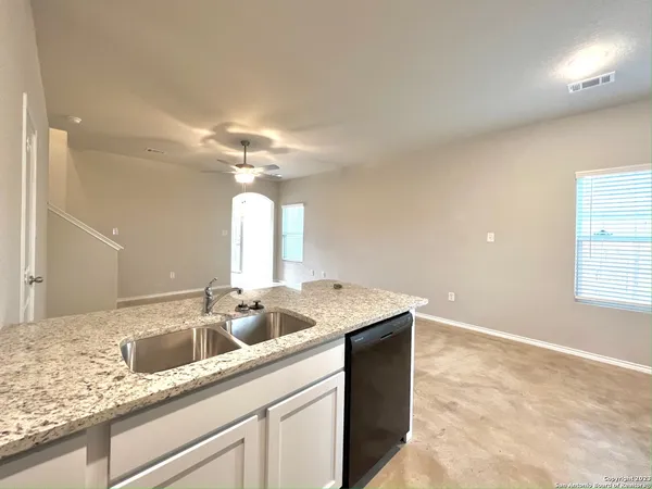 a kitchen with stainless steel appliances granite countertop a sink a stove and a granite counter tops