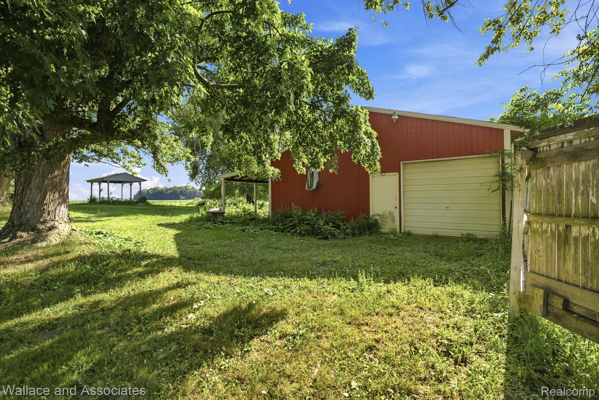 5949 Roach Road Croswell, MI 48422 - Photo 43 of 48 Red barn-style outbuilding with a single garage door and a separate entry door