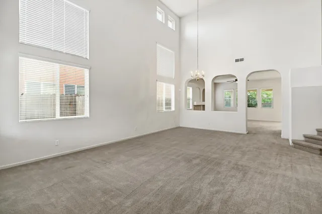 a view of a livingroom with a ceiling fan and window