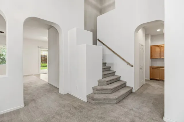 a kitchen with a refrigerator a stove a sink and a oven with wooden cabinets