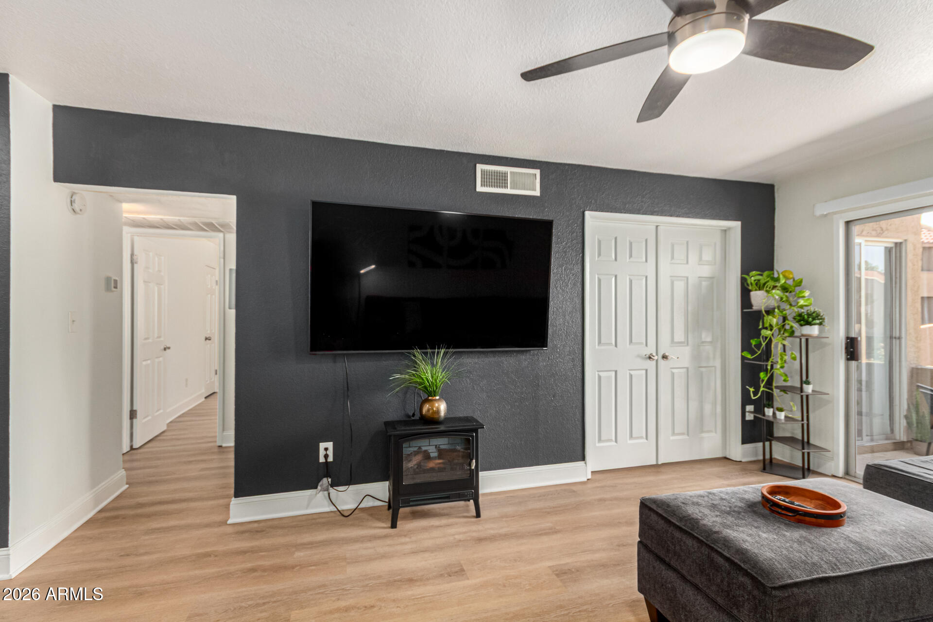 5877 North Granite Reef Road, Unit 1133 Scottsdale, AZ 85250 - Photo 7 of 33 a living room with furniture and a flat screen tv