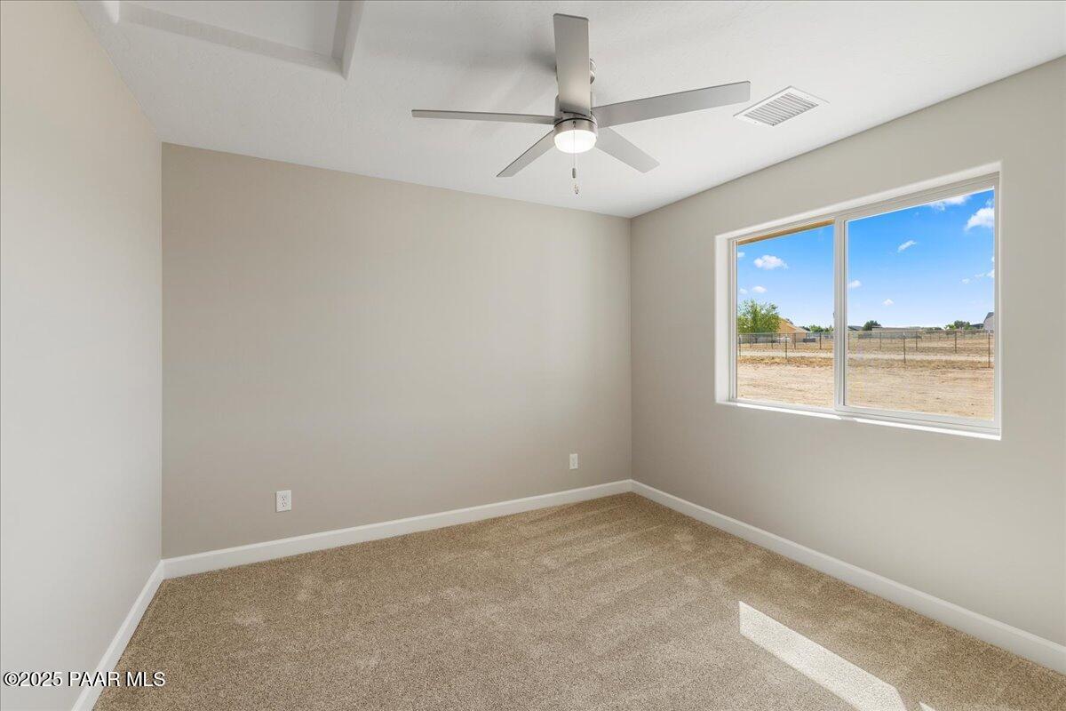 1220 East Cougar Ridge Road Paulden, AZ 86334 - Photo 12 of 30 an empty room with a window and ceiling fan